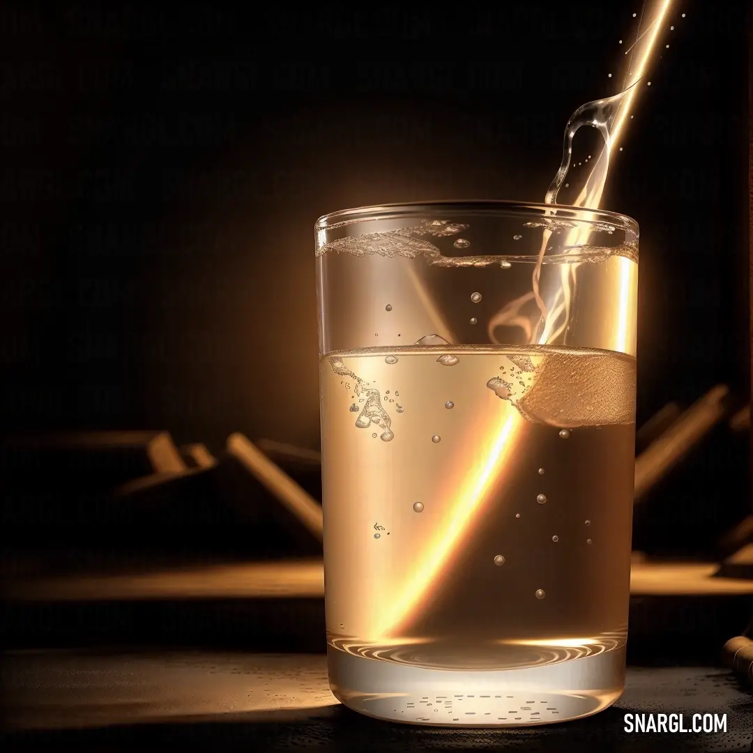 Glass of water with a straw in it and a light shining on the glass behind it