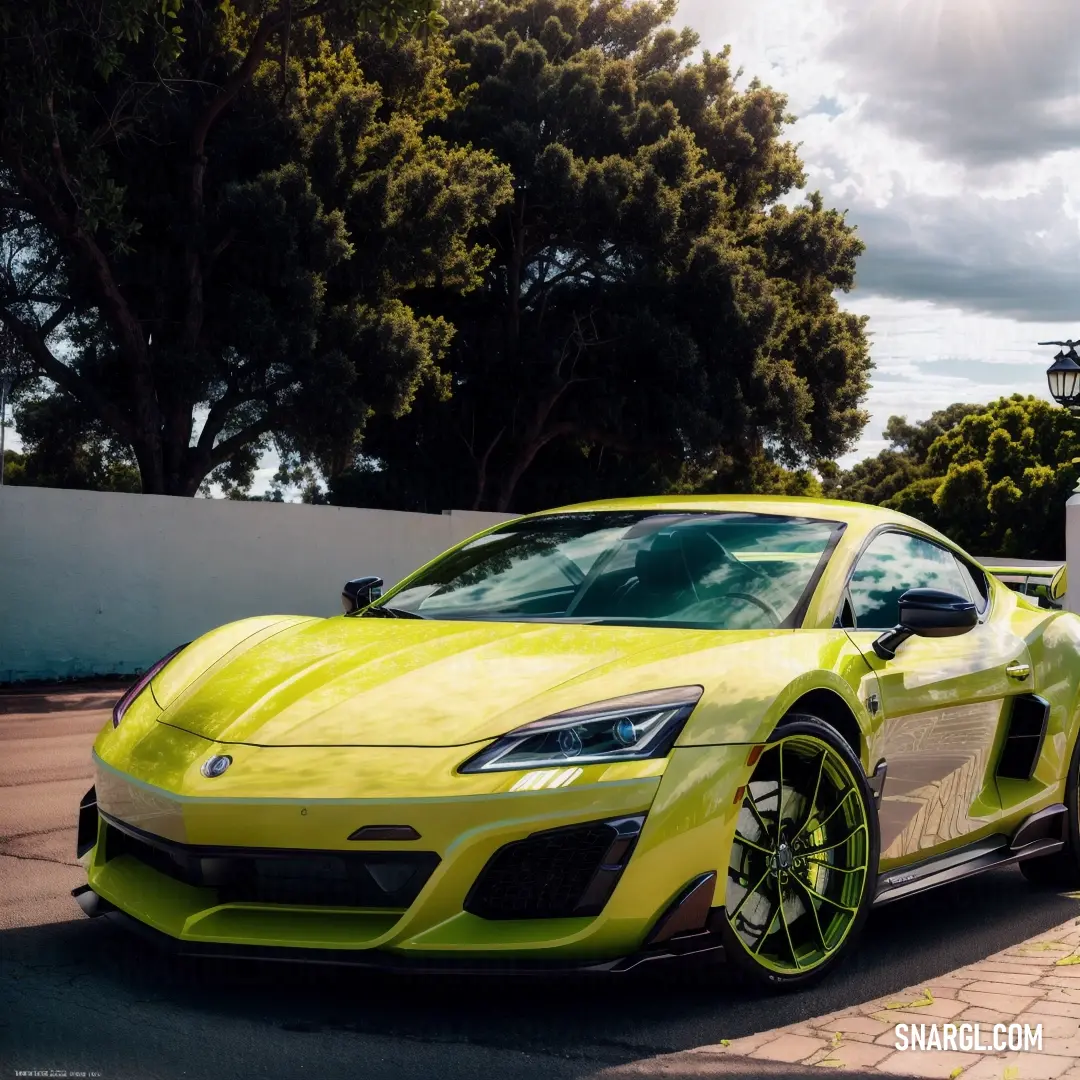 Yellow sports car parked on the side of the road next to a white wall and trees in the background