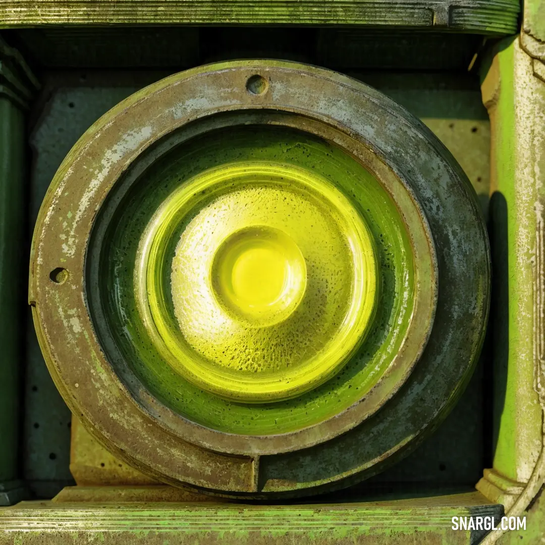 Close up of a green object with a yellow center in the center of it's circle shape. Color Peridot.