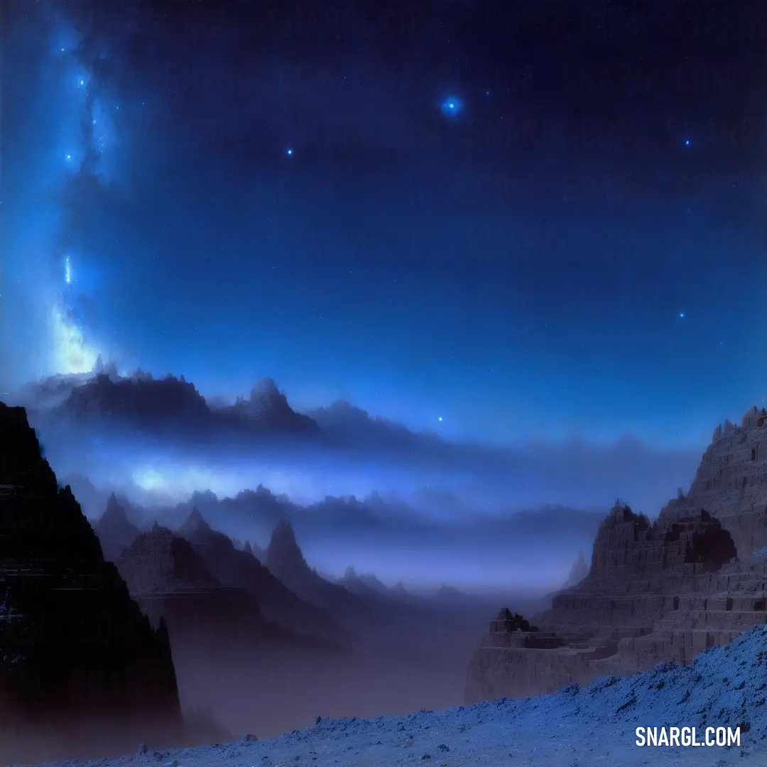 Mountain range with a star filled sky above it and a few clouds in the distance