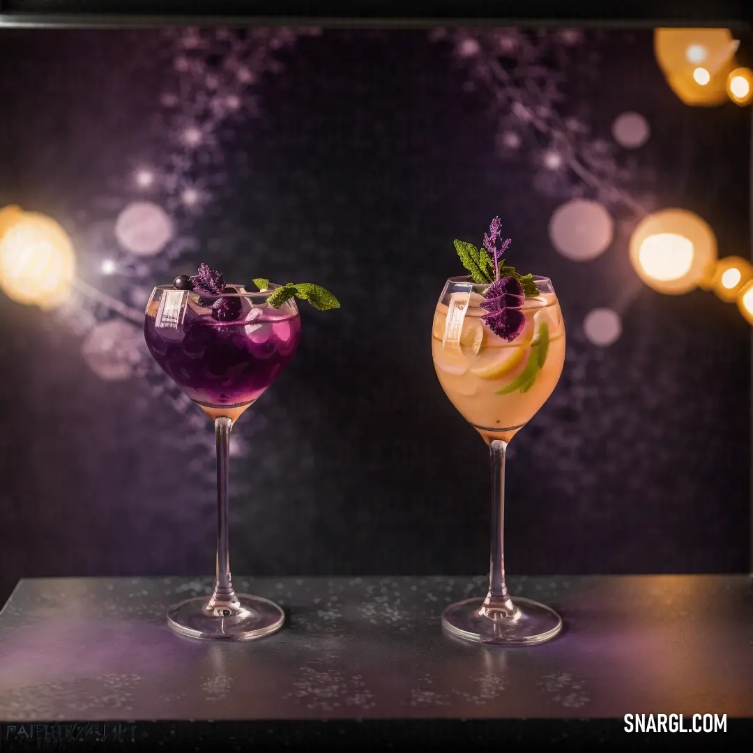 Two glasses of different colored drinks on a table with lights in the background. Example of RGB 217,144,88 color.
