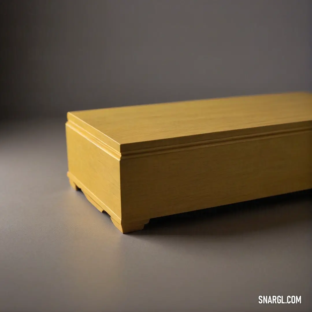 A rustic wooden box sits elegantly atop a table, bathed in natural light, enhancing its textured grain against a soft gray backdrop that adds depth and sophistication to its simple beauty.