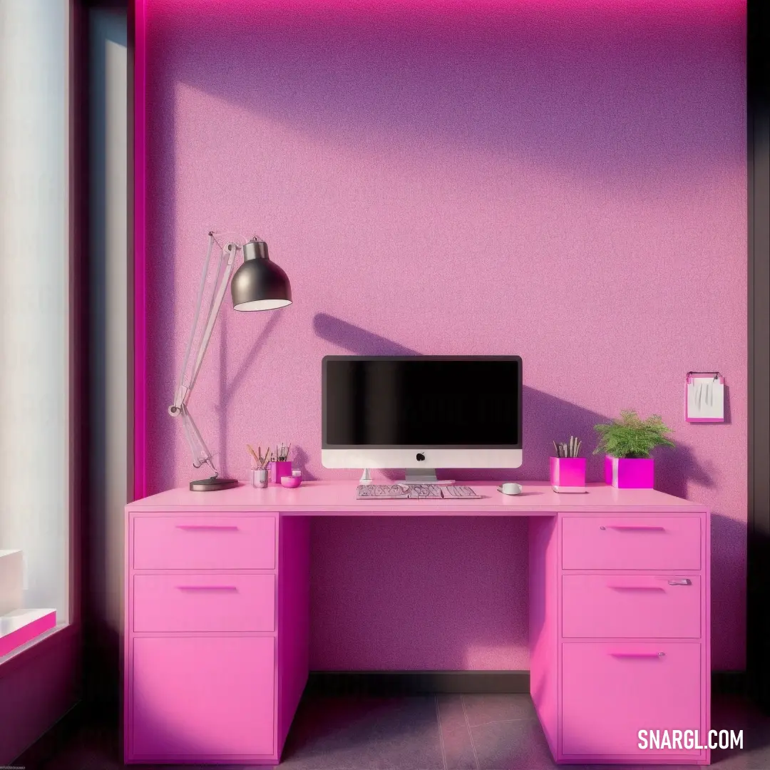 Computer desk with a monitor and a keyboard on it in a room with pink walls