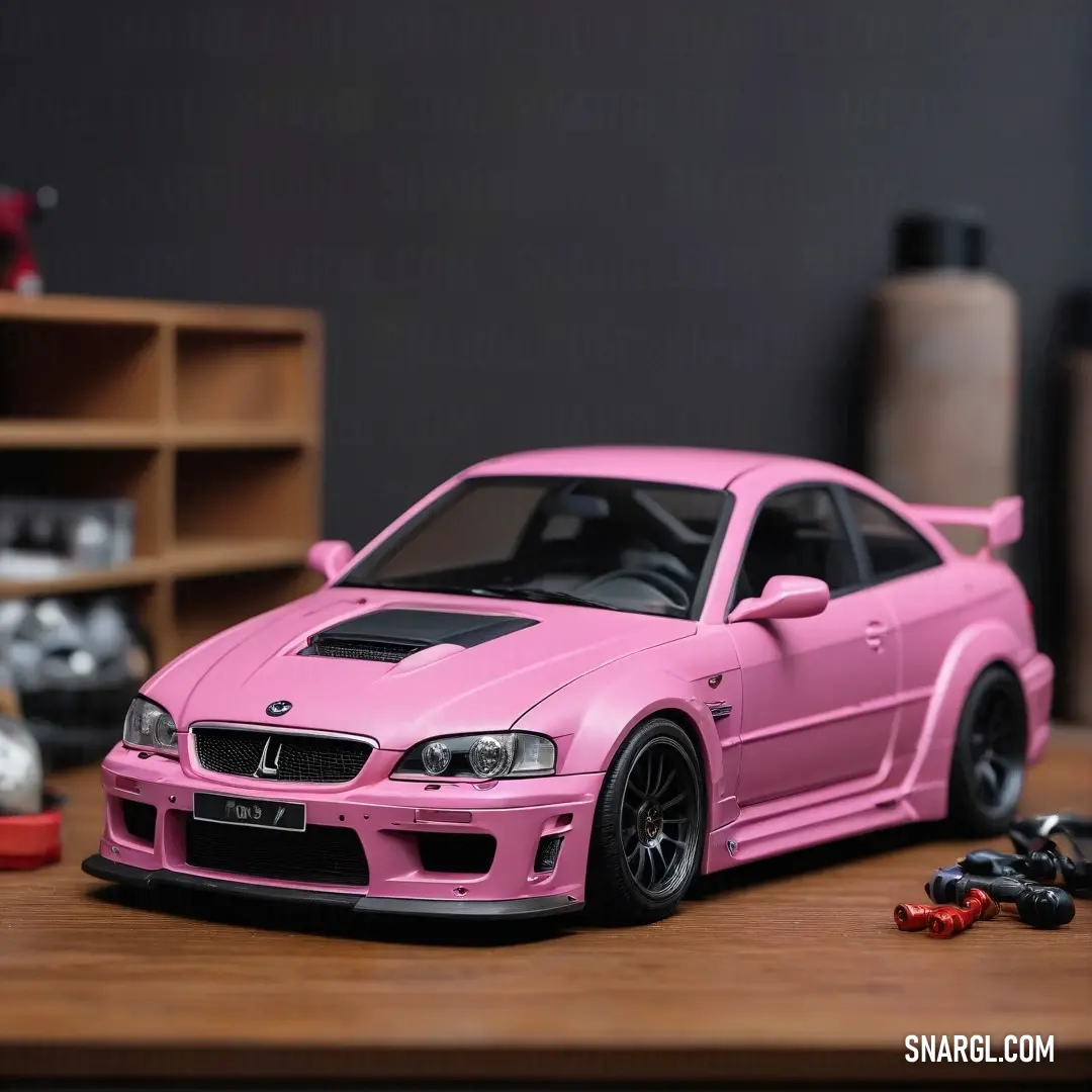 Pink toy car is on a table with other toys and a shelf in the background. Color #F77FBE.