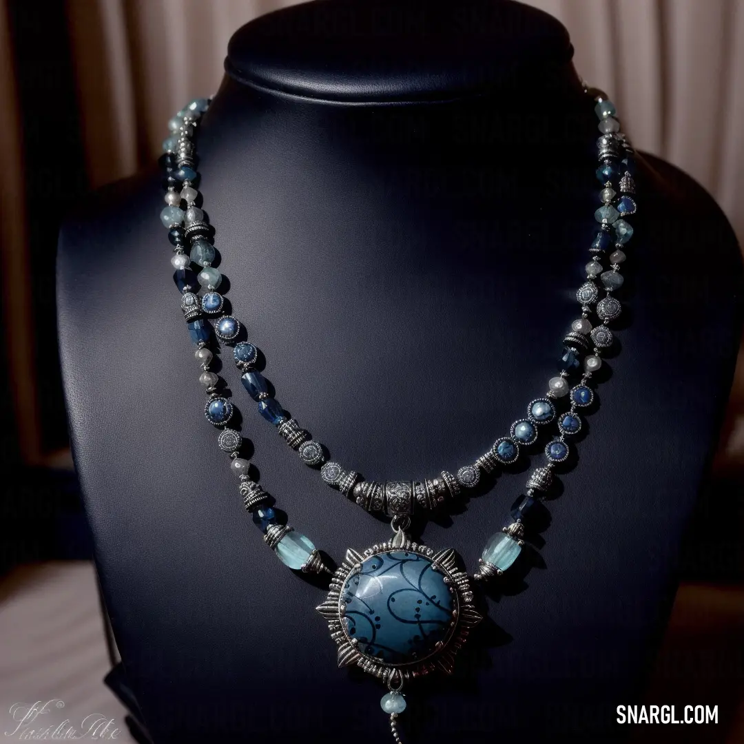 Necklace with a blue stone and a silver clasp on a mannequin head stand on a black mannequin. Example of RGB 0,15,137 color.