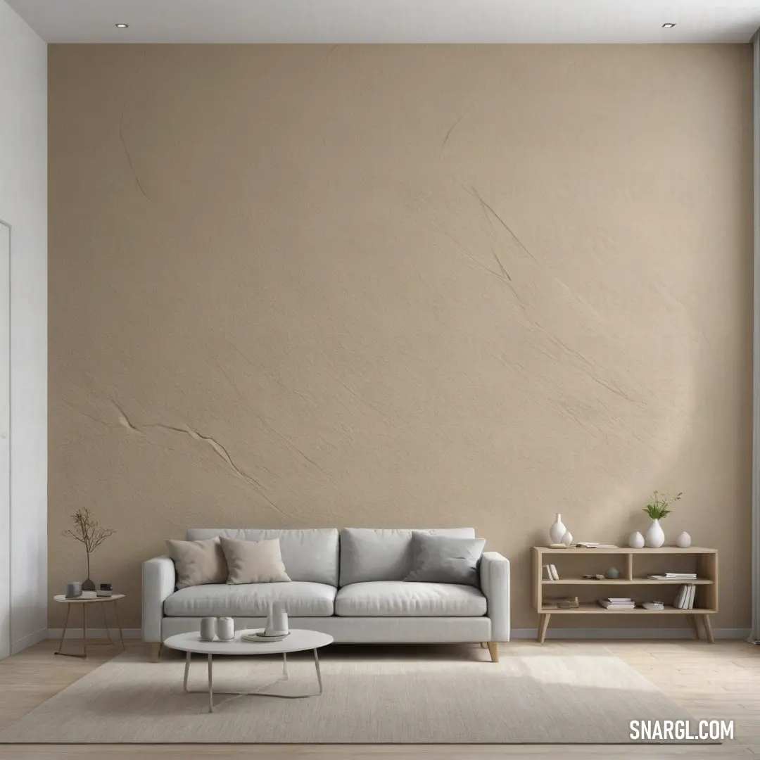 Living room with a couch and a table in it and a wall painted in beige and white. Color CMYK 0,0,1,10.