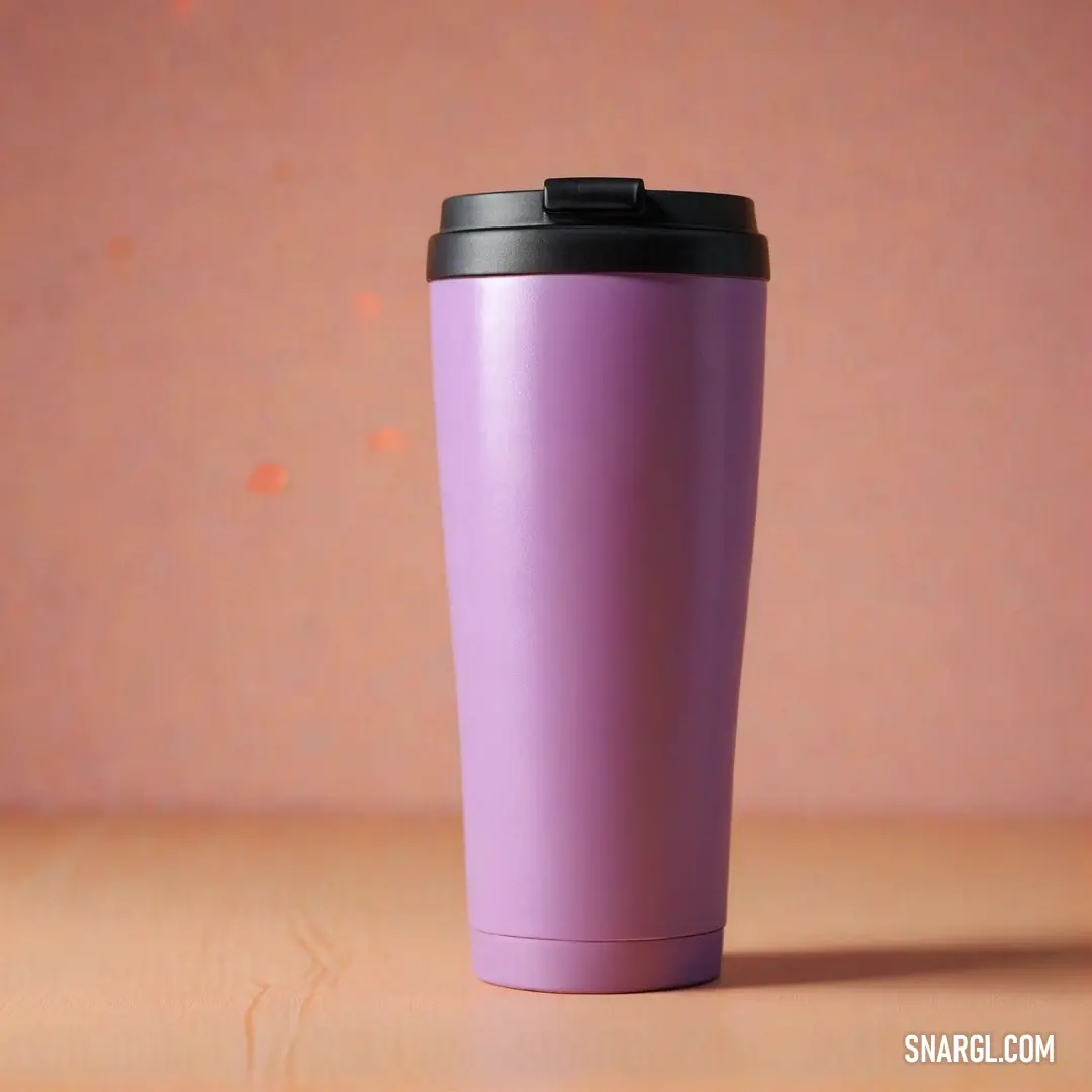 Purple cup with a black lid on a table with a pink wall behind it. Color #DDA0DD.