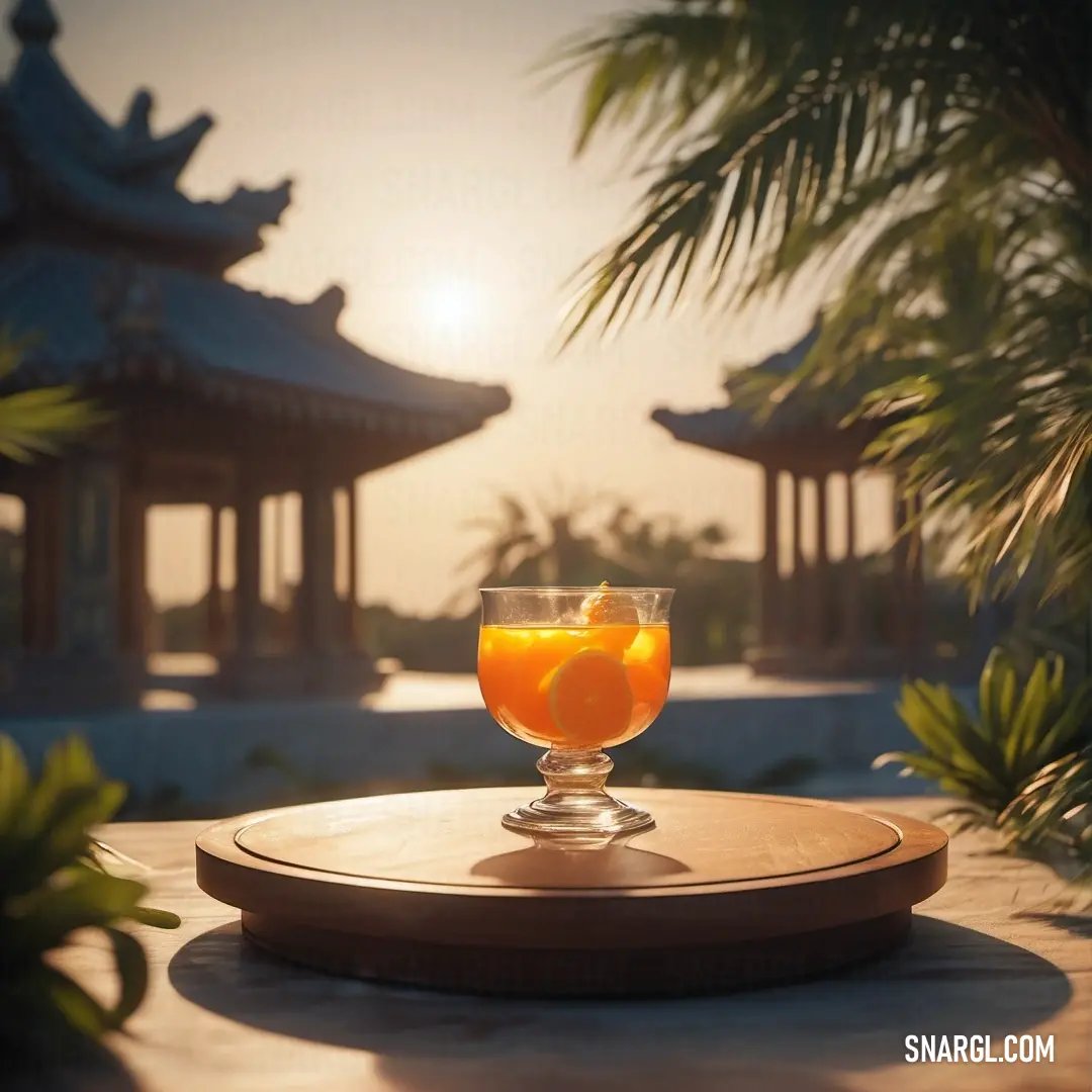 Glass of orange juice on a wooden table with a view of a pagoda in the background. Example of Princeton orange color.