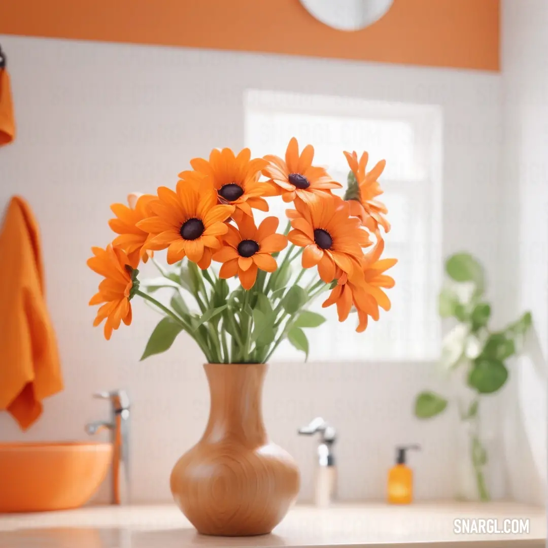 Princeton orange color example: Vase of orange flowers on a counter top in a bathroom with a sink and mirror in the background