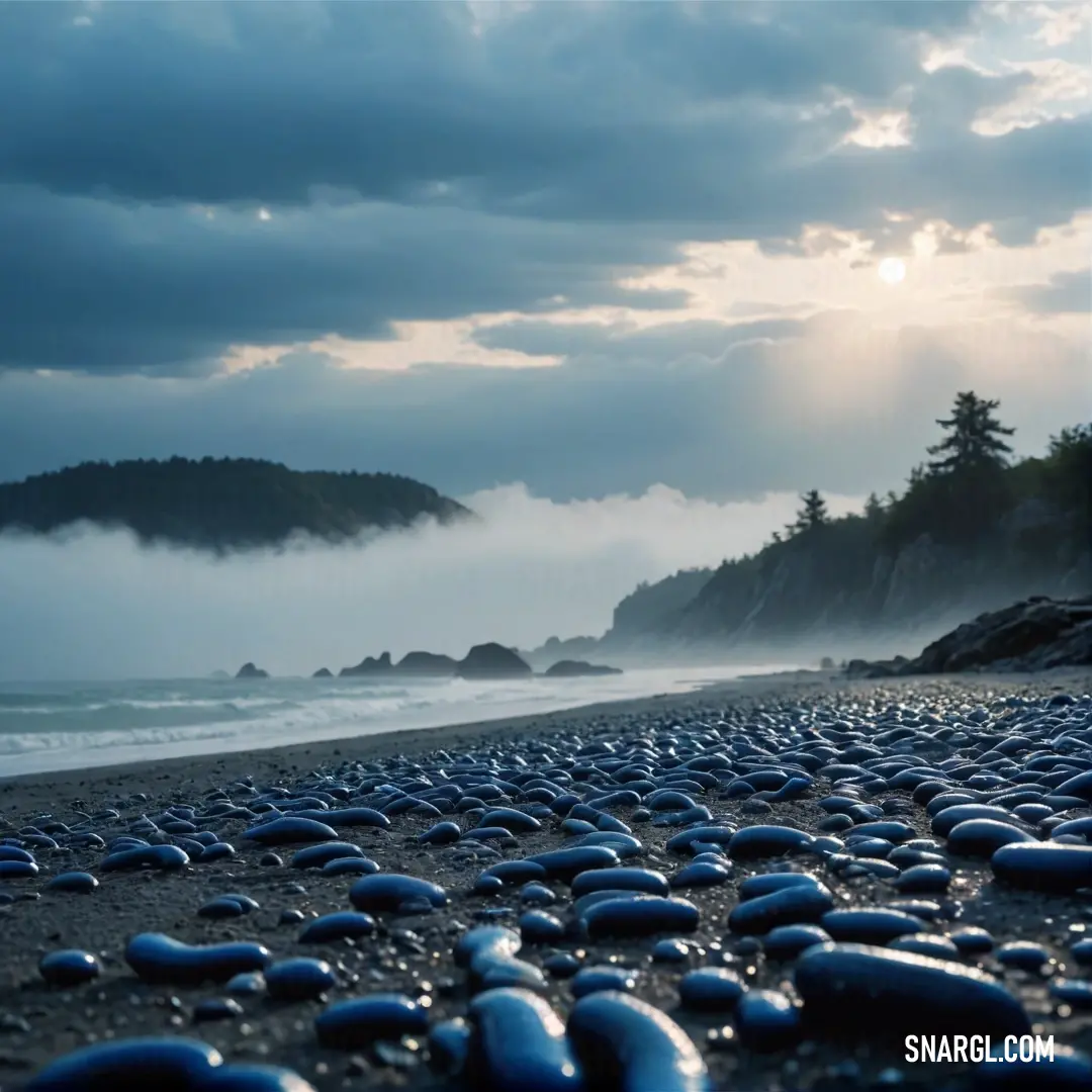 Beach with a lot of rocks on it and a mountain in the background. Example of RGB 0,49,83 color.