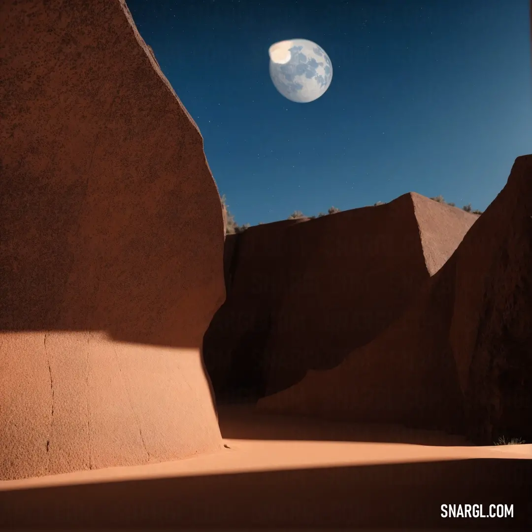 Full moon is seen in the sky above a desert landscape with rocks and sand