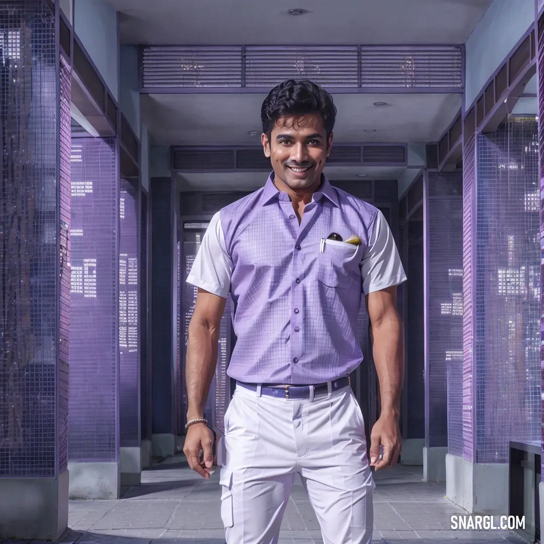Man standing in a hallway with purple blinds on the walls and a purple shirt on his chest