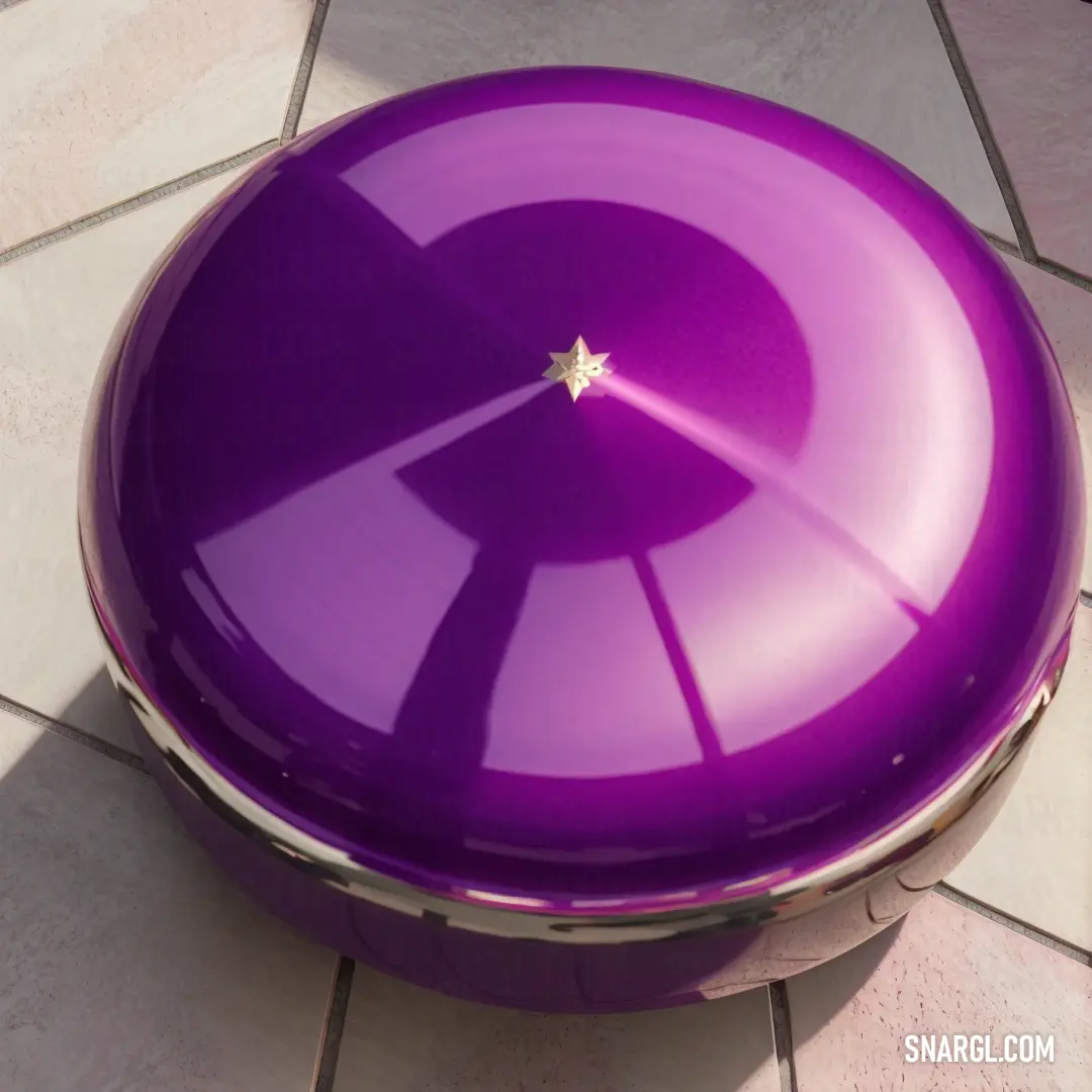 Purple color. Purple object on a tile floor with a star on it's center piece in the center of the picture