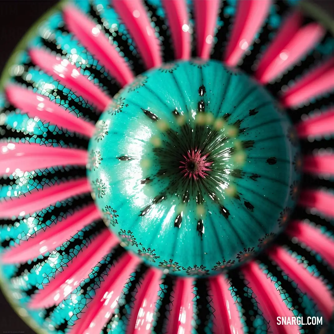 Close up of a colorful object with a black background and pink and blue stripes on it's center