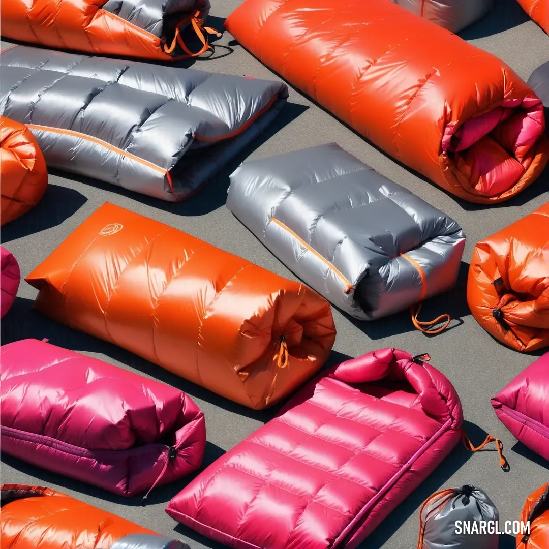 A cheerful cluster of colorful sleeping bags sprawled on the ground presents an invitation to cozy nights under the stars, evoking a sense of adventure and the joy of togetherness in outdoor gatherings.