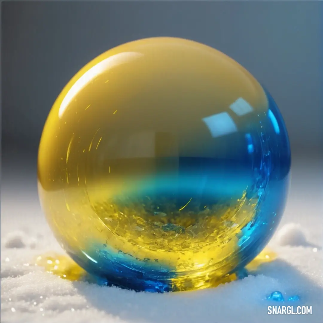 Yellow and blue ball on top of snow covered ground with a blue and yellow substance in the middle. Example of #D6BE36 color.