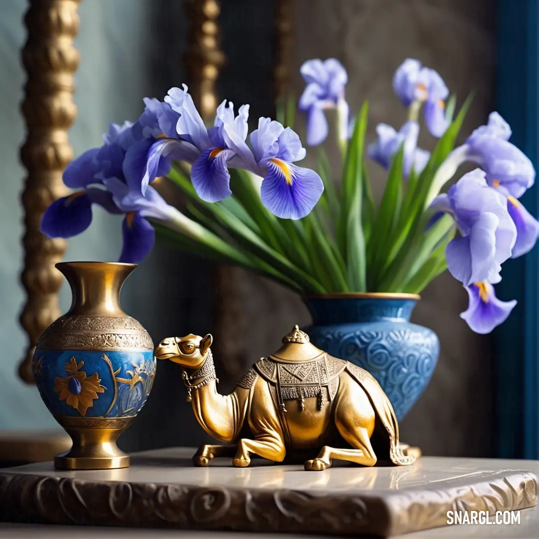Vase with flowers and a camel statue on a table with a blue background. Color CMYK 100,83,0,20.