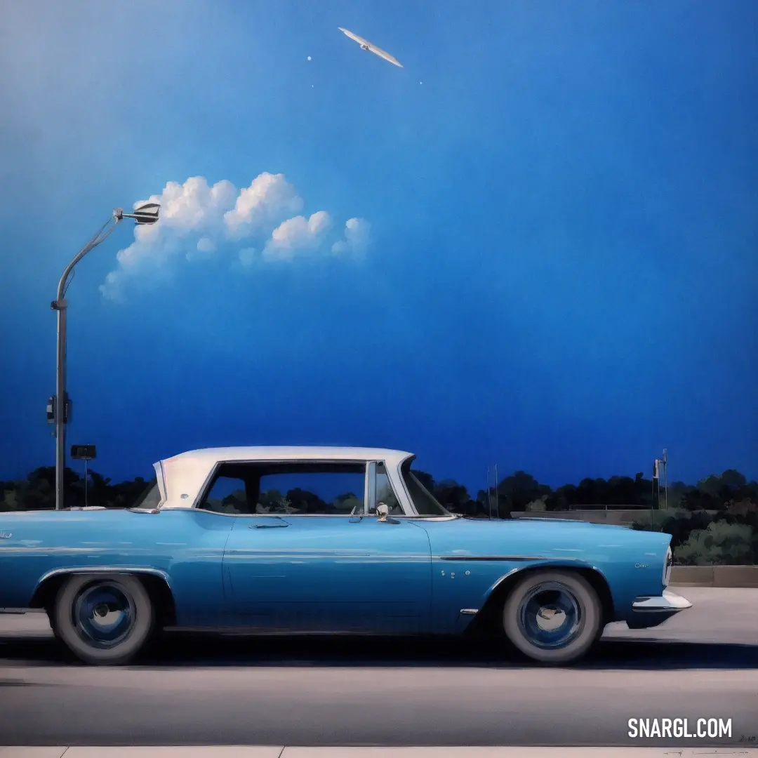 Blue car is parked on the street under a street light and a street light with a kite flying in the sky. Color RGB 91,166,192.