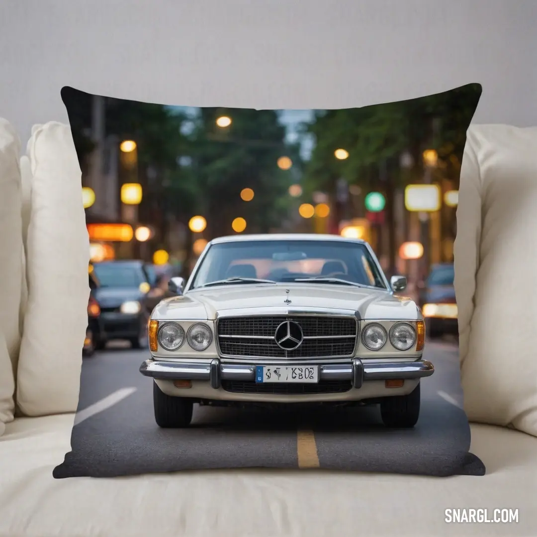 A luxurious Mercedes-Benz throw pillow set against a chic couch, illuminated by city lights at night. The intricate details of the pillow design reflect sophistication, elevating the room's ambiance with modern elegance and style.