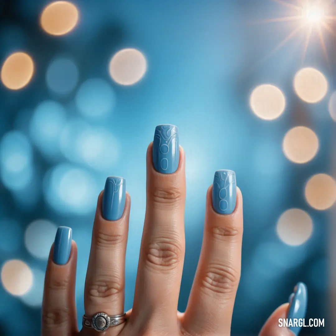 Woman's hand with a blue manicure and a ring on it's finger, with a blurry background. Color RGB 150,198,221.