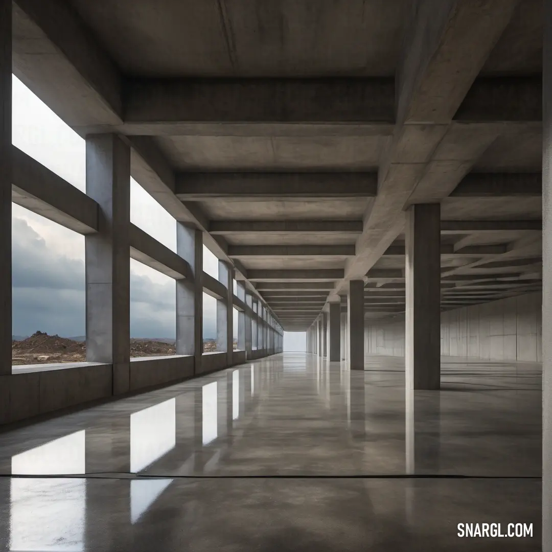 Long hallway with large windows and concrete walls and flooring with a sky background. Example of RAL 870-M color.