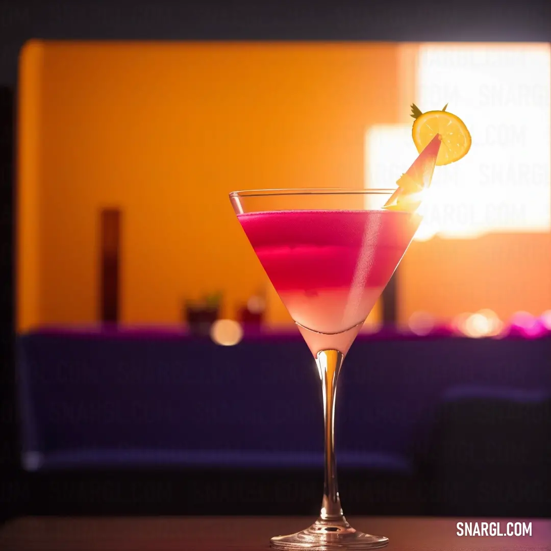 Pink drink with a lemon wedge in it on a table in a room with a purple couch and a yellow wall