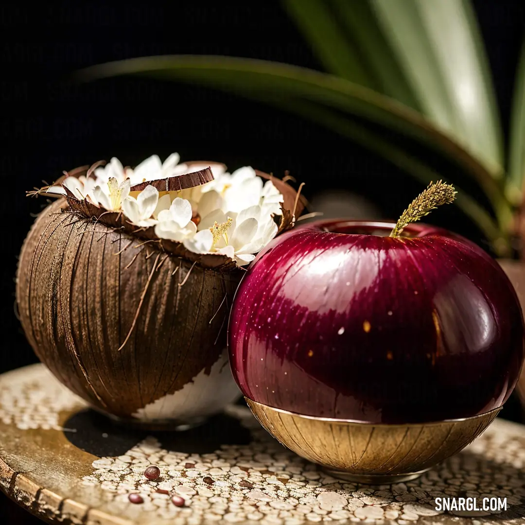 A vibrant display of raspberry-inspired colors: A red onion and a coconut sit side by side on a table, with lush greenery softly blurred in the background. The scene is a perfect blend of nature’s rich textures and warm tones.