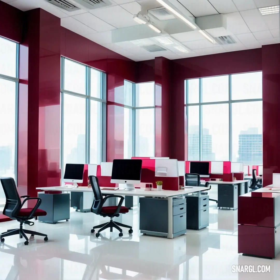 A warm raspberry-colored room filled with an inviting arrangement of desks and chairs, illuminated by natural light streaming through a large window. The cozy atmosphere invites collaboration and creativity within its vibrant context.