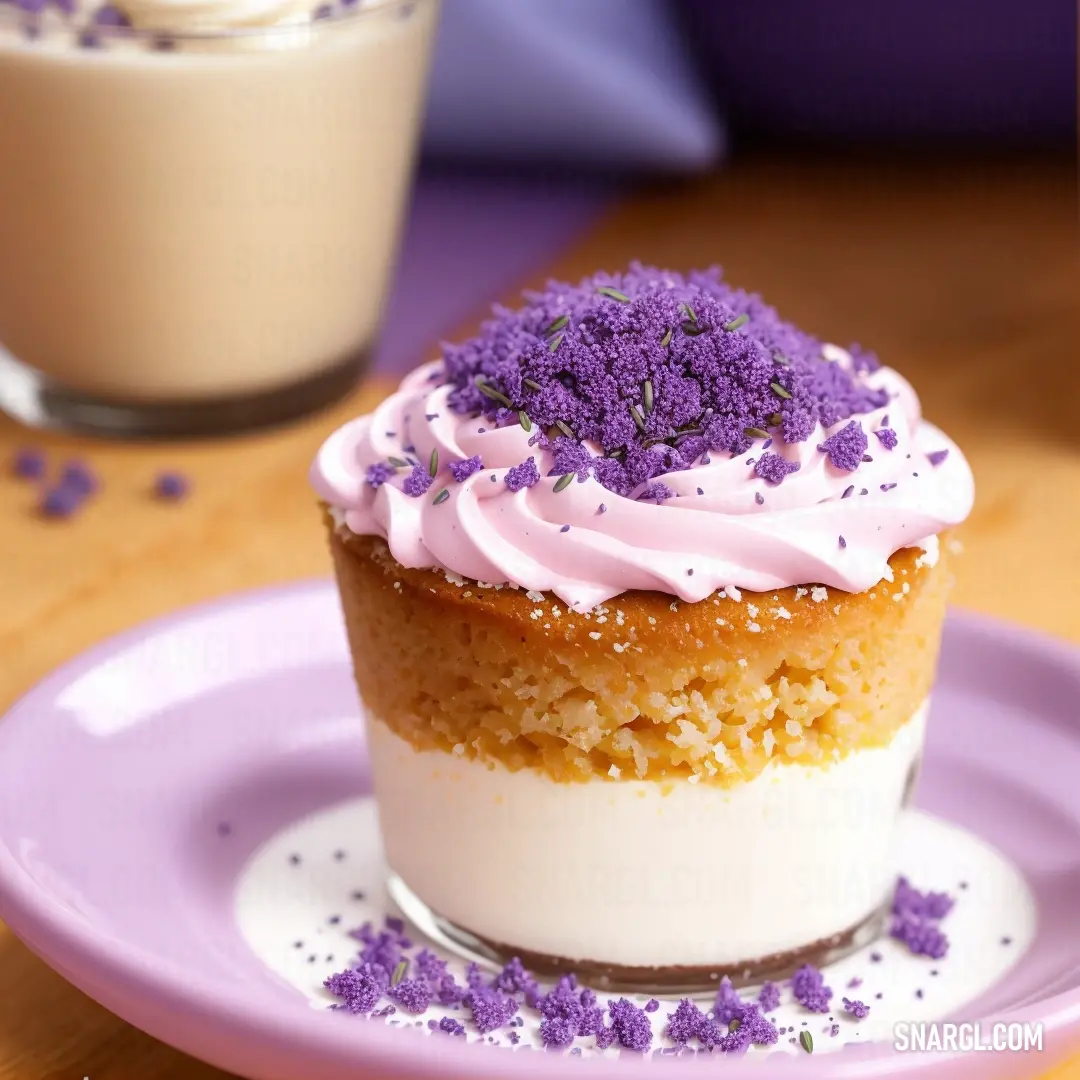 Cupcake with purple sprinkles on a plate next to a drink on a table