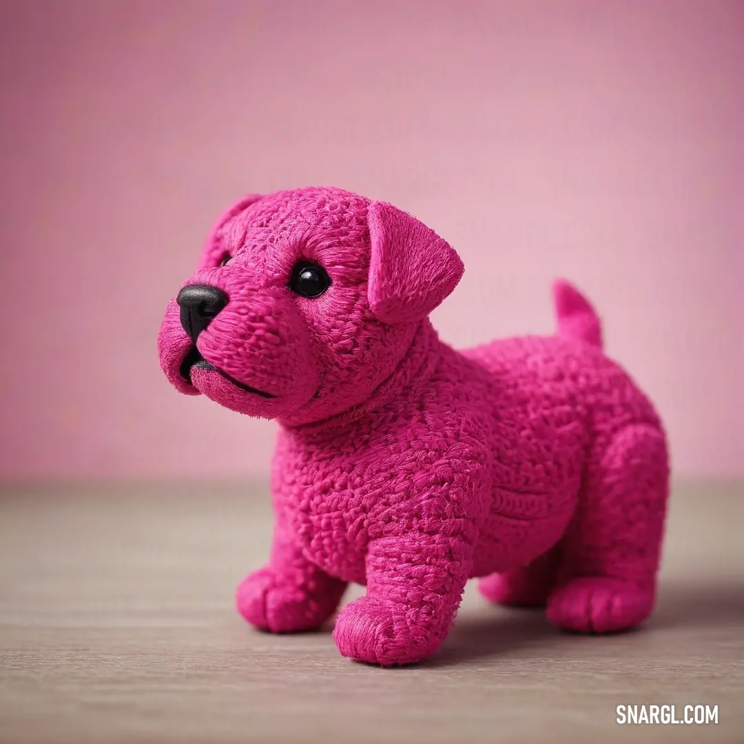 Pink dog toy on a table next to a pink wall. Example of CMYK 0,84,53,11 color.