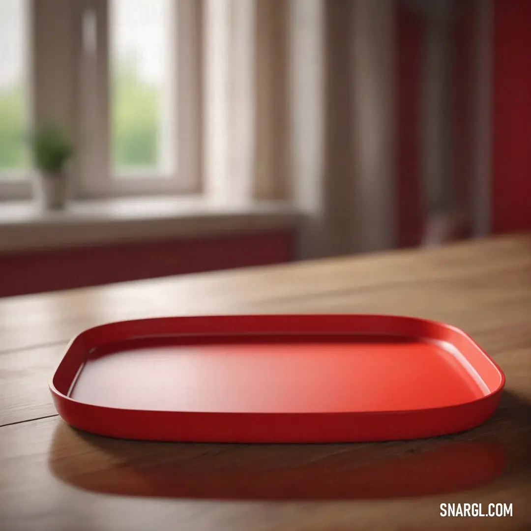 Red tray on top of a wooden table next to a window with a potted plant in the background. Color #FF5349.