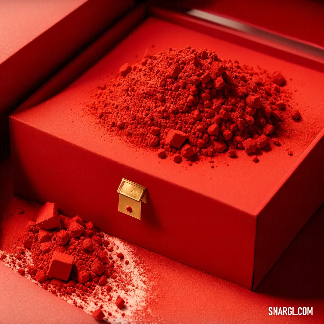 Red box with a gold lid and a pile of red powder on the floor next to it