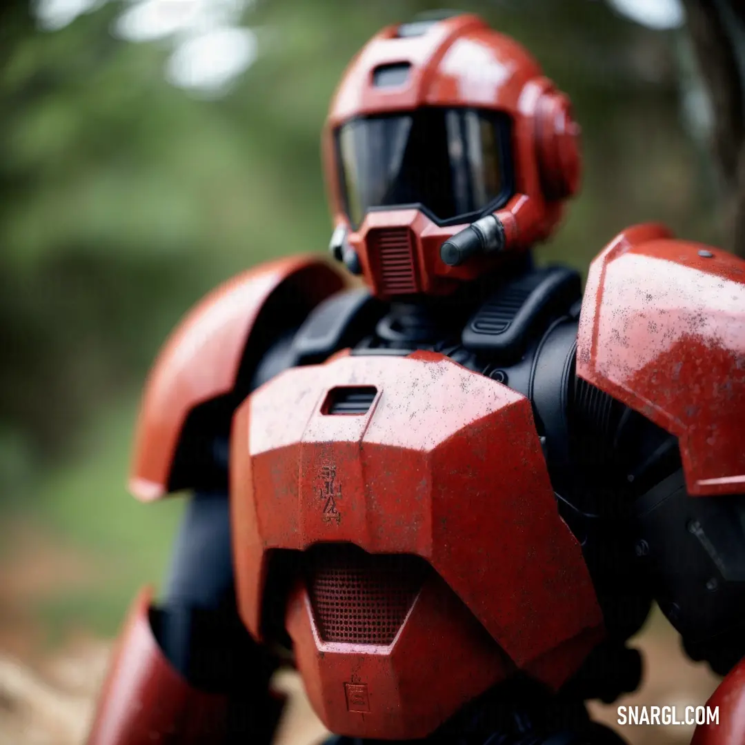 Red robot with a helmet on standing in the woods with trees in the background