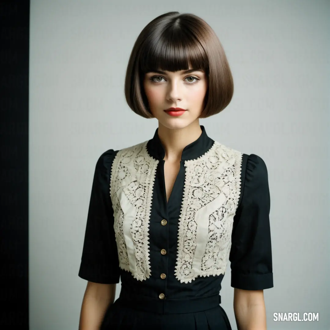 Woman with a short bob cut wearing a black dress and a white shirt with a lace collar