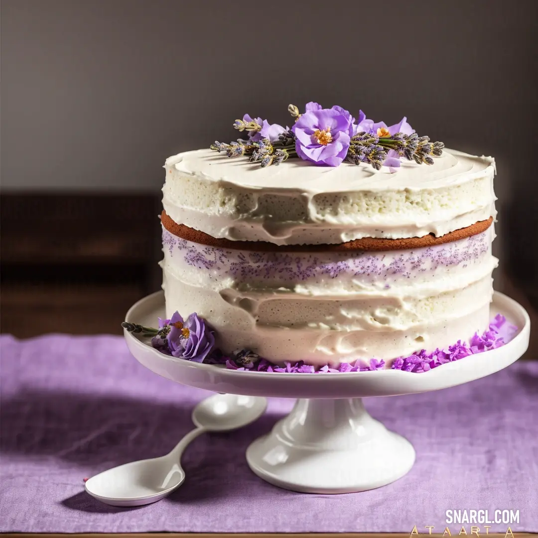 Rich lilac color. Cake with frosting and purple flowers on a plate with a spoon on a purple cloth with a wooden table