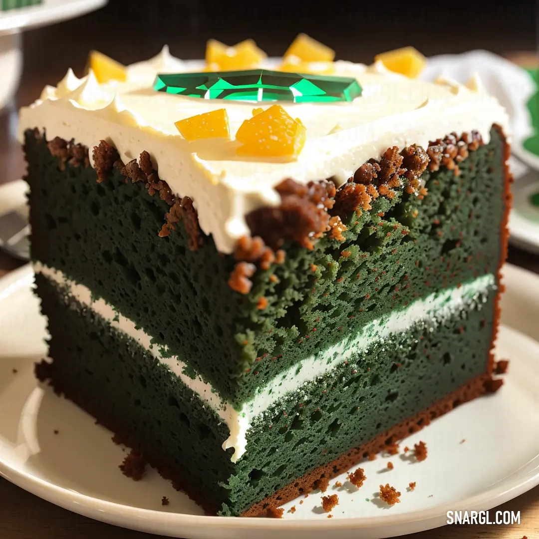 Slice of cake on a plate with a green and white frosting and a green and white decoration. Color #414833.