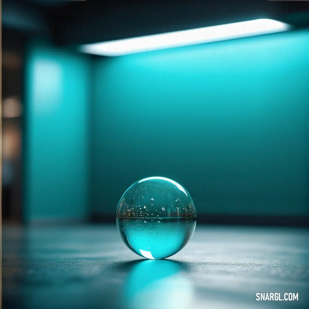 Glass ball on top of a table in a room with a blue wall behind it and a light coming through the window. Example of Robin Egg Blue color.