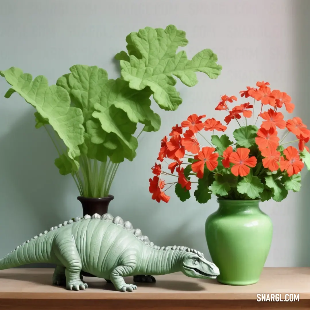 Green vase with flowers and a green toy alligator next to it on a table. Example of RGB 227,38,54 color.