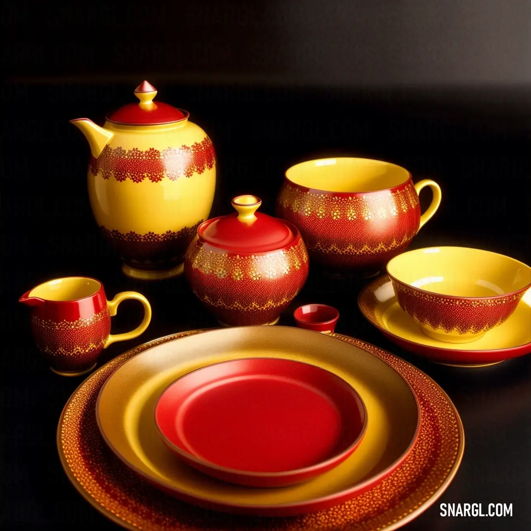 Rosso corsa color. Red and yellow plate and a yellow and red tea set on a black tablecloth with a red
