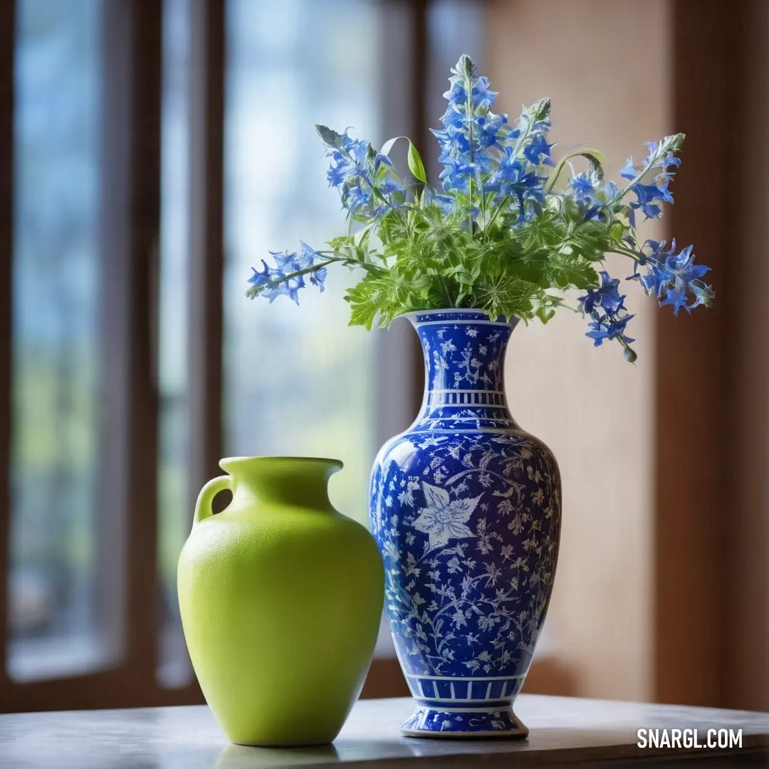 Blue and white vase with blue flowers in it and a green vase. Color RGB 65,105,225.