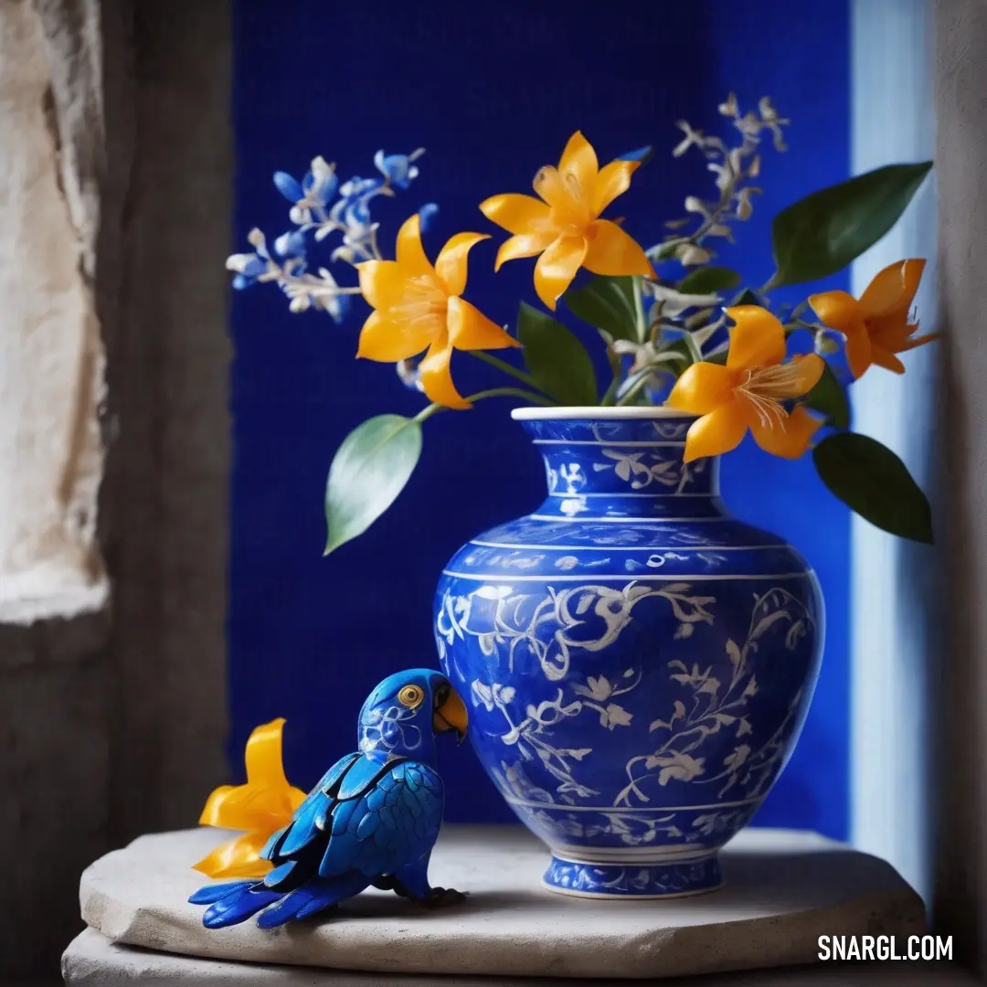 Blue vase with yellow flowers and a blue bird on a table. Example of CMYK 71,53,0,12 color.