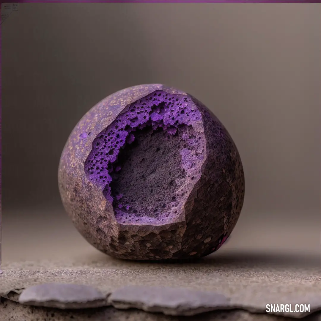 Rock with a hole in it on a rock slab with a purple border around it