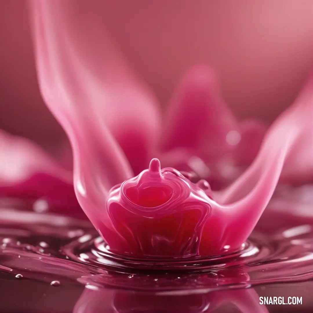 A captivating pink flower adorned with glistening water droplets rests against a soft, pink backdrop. The delicate petals, vivid in hue, showcase the beauty of nature, making it an enchanting focal point.