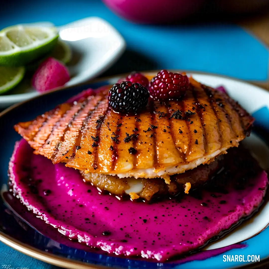 Plate with a piece of fish and berries on it with a lime wedge on the side of the plate