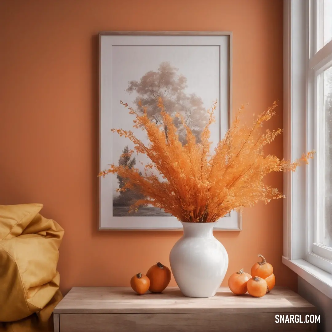 Vase with some orange flowers in it on a table next to a window with a picture on it. Color Ruddy brown.