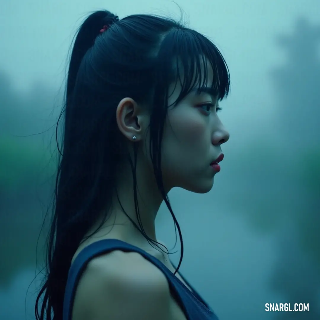 With her eyes gently closed, this girl with a ponytail revels in the rain's embrace, embodying pure tranquility and joy amidst the rhythmic patter of droplets. A girl stands peacefully in the rain, her long hair cascading down as she closes her eyes, embracing the soothing droplets that dance around her in a moment of serenity.
