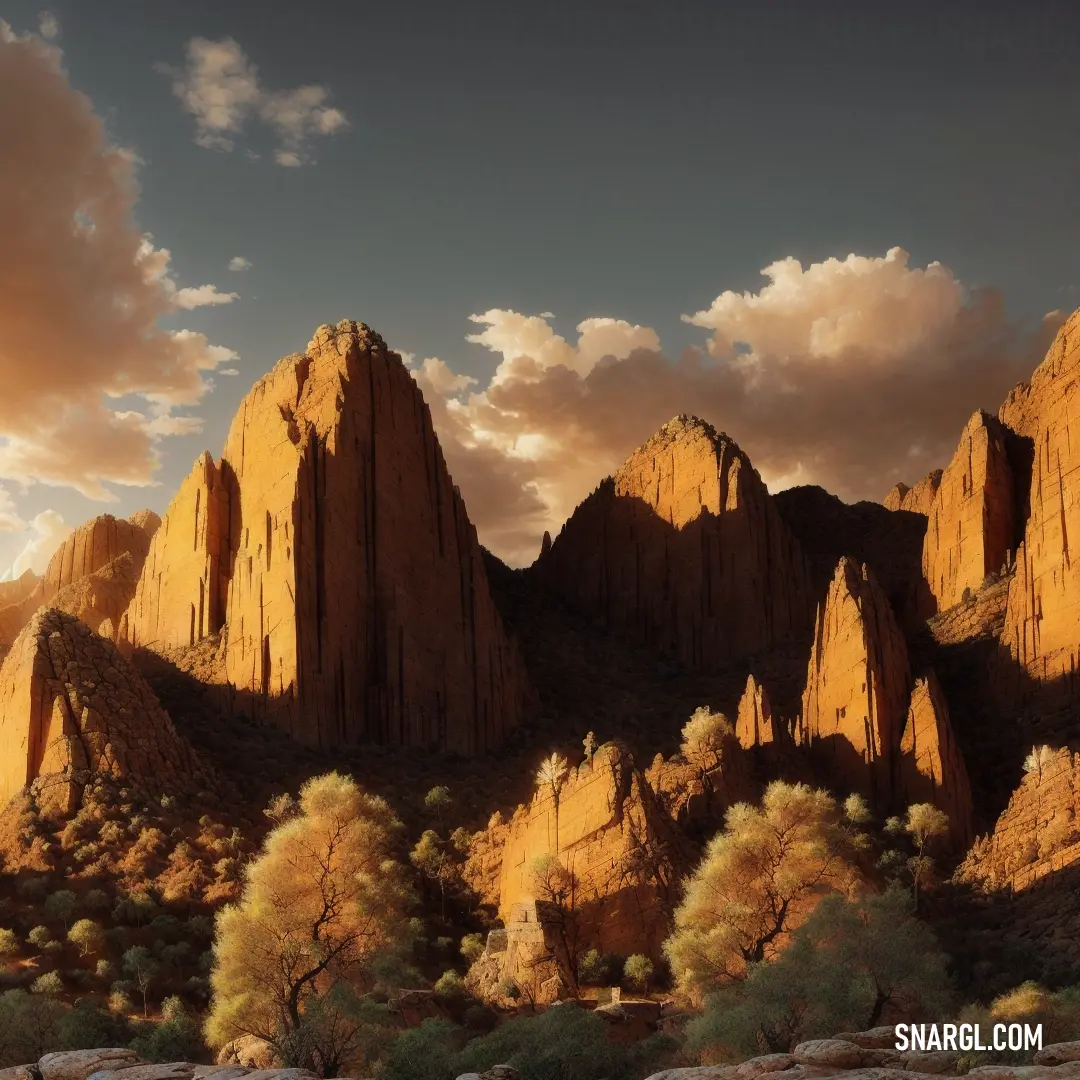 Mountain range with a few trees in the foreground and a cloudy sky in the background