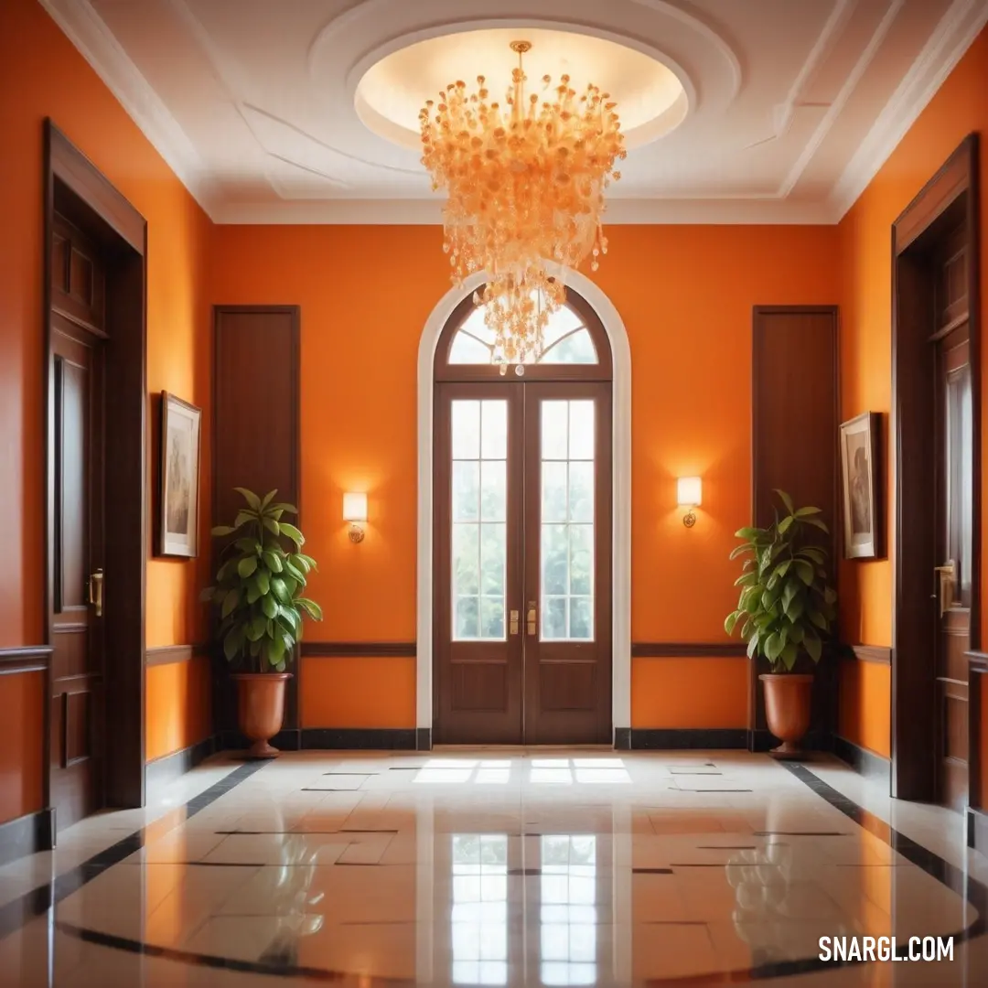 Foyer with a chandelier and two potted plants on the floor and a door way leading to another room. Color Rust.