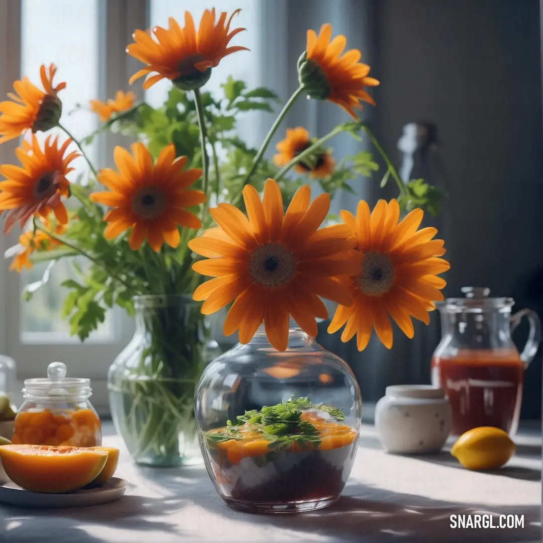 Vase filled with orange flowers next to a bowl of fruit and a vase filled with water and oranges. Color #B7410E.