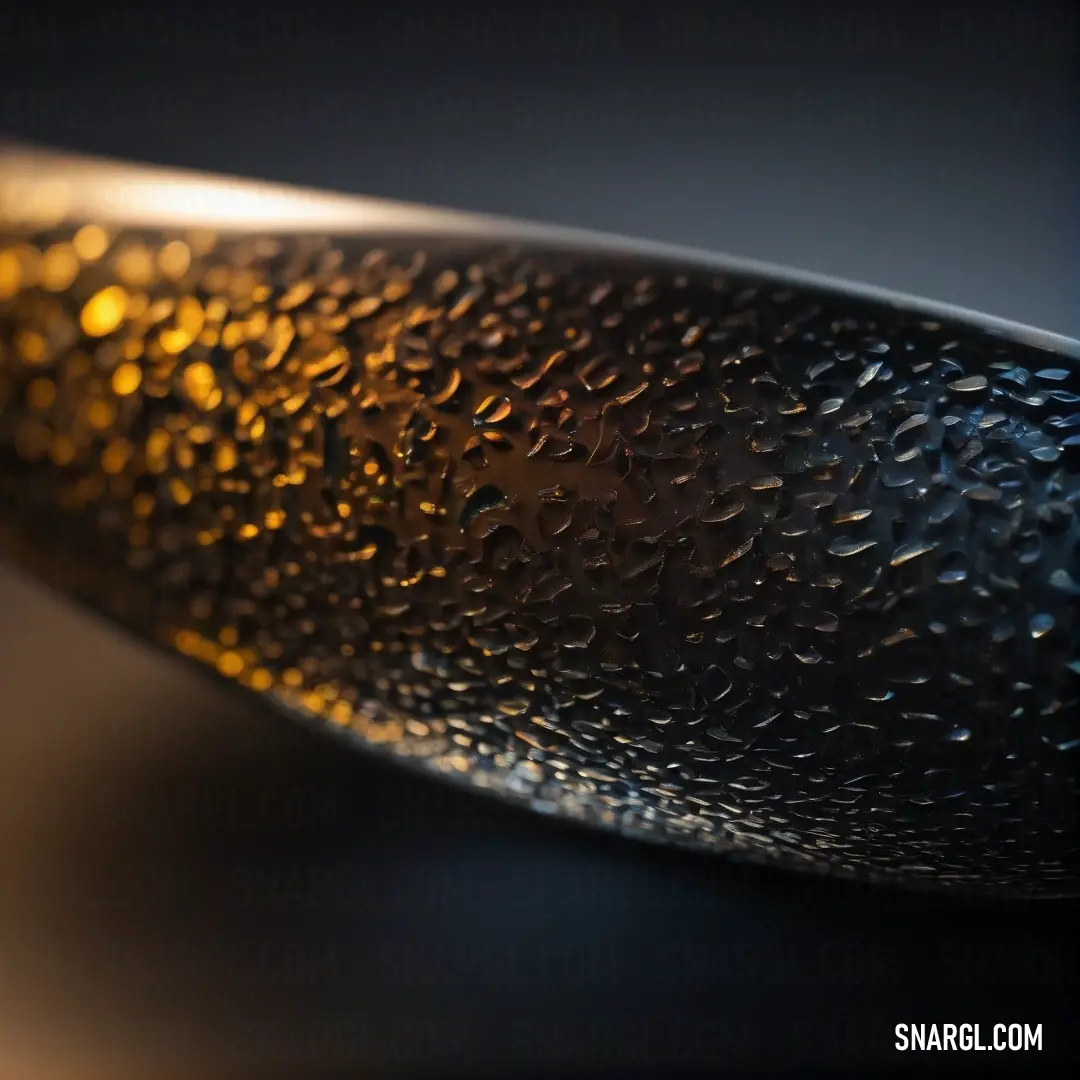 A close-up of a stunning glass bowl adorned with glistening water droplets, set against a smooth black backdrop. This image emphasizes texture and clarity, inviting admiration and curiosity in CMYK 0,50,86,45 colors.